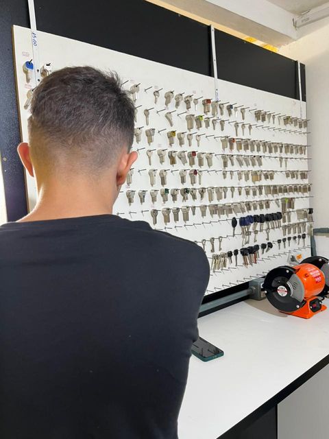 Técnico selecionando chave no painel — Chaveiro Líder